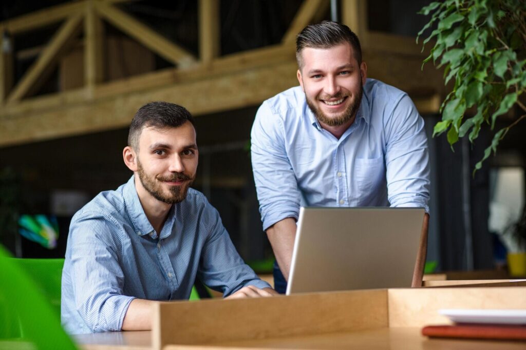 picture-handsome-businessman-listening-his-colleague-partner-concerning-ner-business-system-while-working-laptop-computer-office-interior_549566-850